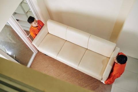 movers-carrying-leather-sofa